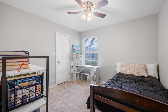 carpeted bedroom with a ceiling fan and baseboards