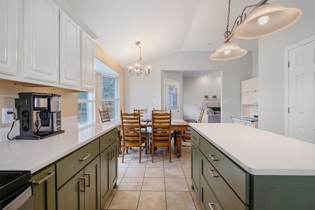 kitchen with lofted ceiling, light countertops, white cabinetry, and green cabinetry