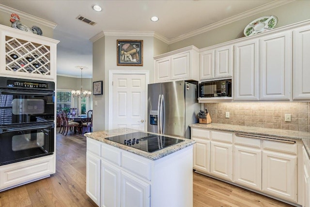 8001 Bell Mountain Dr, Austin, TX 78730 - kitchen featuring black appliances, a chandelier, light wood-style flooring, crown molding, and white cabinetry