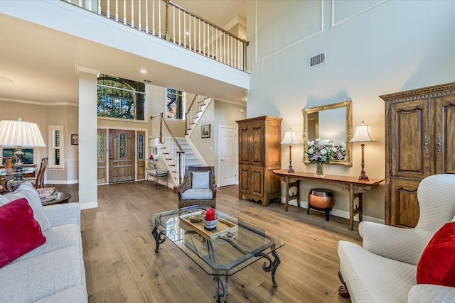 8001 Bell Mountain Dr, Austin, TX 78730 - living room with a towering ceiling, stairs, wood finished floors, and crown molding