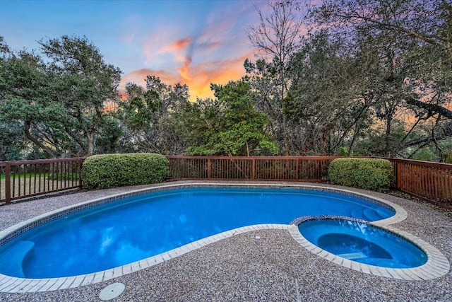 8001 Bell Mountain Dr, Austin, TX 78730 - view of pool with a fenced backyard, a pool with connected hot tub, and view of scattered trees