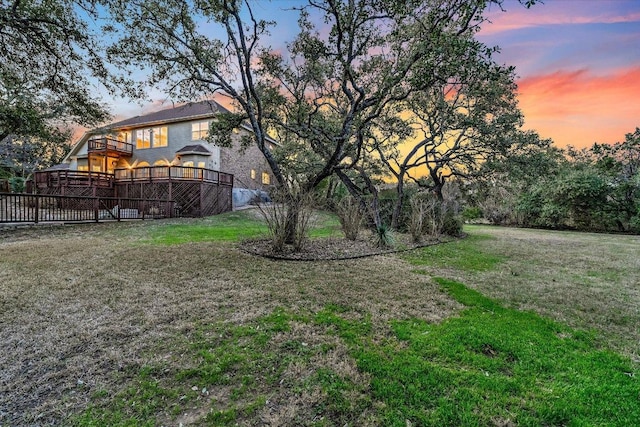 8001 Bell Mountain Dr, Austin, TX 78730 - yard at dusk featuring a wooden deck, a yard, and a balcony