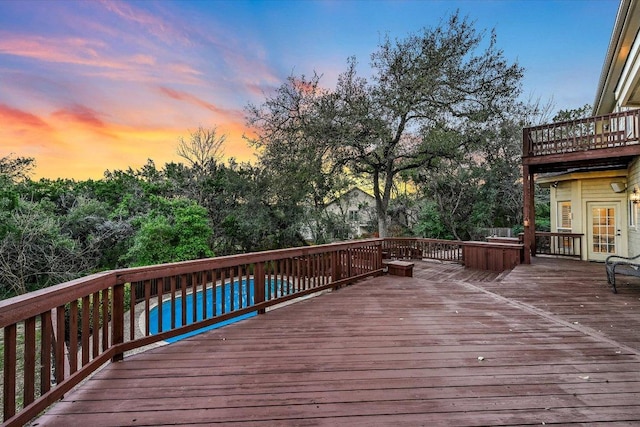 8001 Bell Mountain Dr, Austin, TX 78730 - deck at dusk with an outdoor pool and view of scattered trees