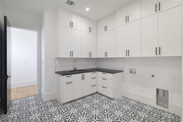 2701 Toro Canyon Rd Unit B, Austin, TX 78746 - laundry room with cabinet space, washer hookup, electric dryer hookup, light tile patterned floors, and recessed lighting