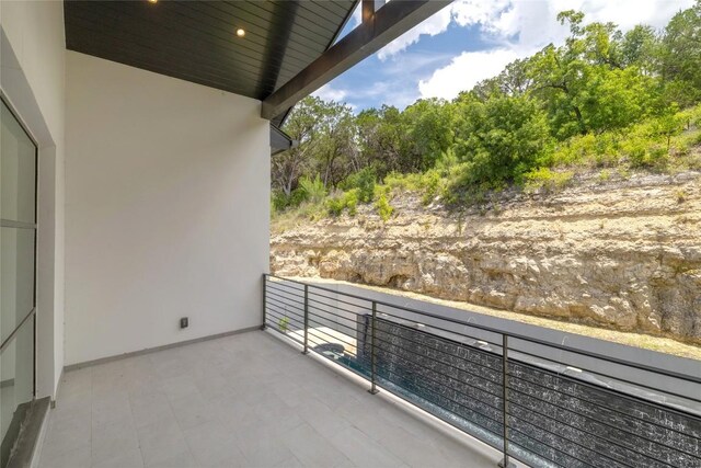 2701 Toro Canyon Rd Unit B, Austin, TX 78746 - balcony featuring view of wooded area