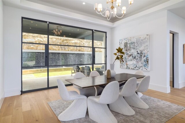 2701 Toro Canyon Rd Unit B, Austin, TX 78746 - dining room featuring a chandelier, light wood-style flooring, a tray ceiling, and recessed lighting