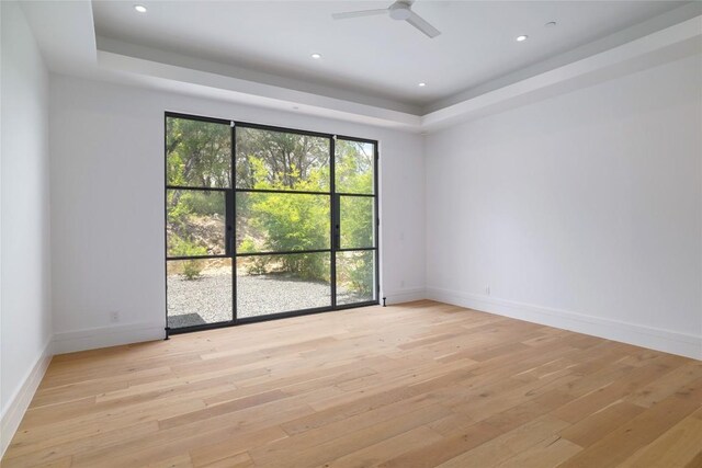 2701 Toro Canyon Rd Unit B, Austin, TX 78746 - unfurnished room with a tray ceiling, light wood-style floors, ceiling fan, and recessed lighting