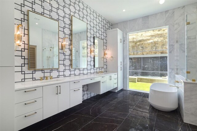 2701 Toro Canyon Rd Unit B, Austin, TX 78746 - full bath with a freestanding tub, double vanity, plenty of natural light, marble tiled floors, and recessed lighting