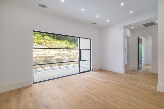 2701 Toro Canyon Rd Unit B, Austin, TX 78746 - spare room featuring light wood-style flooring and recessed lighting