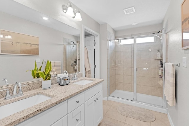 197 Eves Necklace Dr, Buda, TX 78610 - bathroom with a stall shower, a sink, tile patterned flooring, and visible vents
