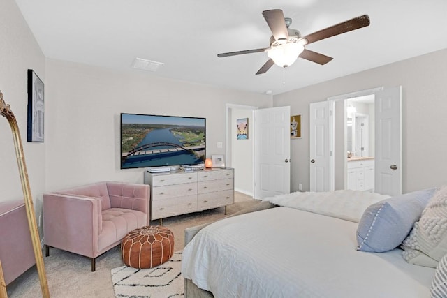 197 Eves Necklace Dr, Buda, TX 78610 - bedroom with light carpet, ensuite bath, and a ceiling fan