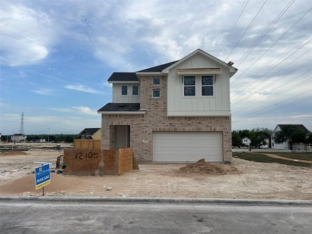 12105 Cearley Dr, Austin, TX 78758 - view of front of property with brick siding, board and batten siding, a shingled roof, and a garage