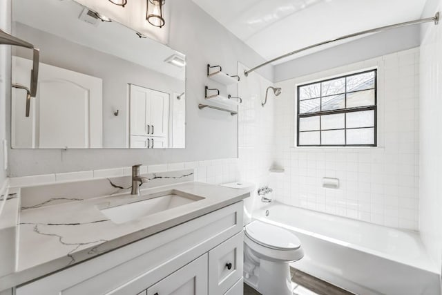 bathroom with bathing tub / shower combination, toilet, tile walls, visible vents, and vanity
