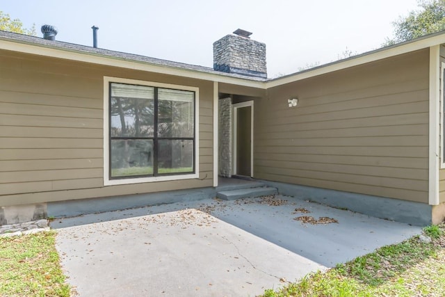 2009 Scofield Ln, Austin, TX 78727 - property entrance with a patio area and a chimney