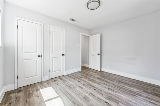 2009 Scofield Ln, Austin, TX 78727 - unfurnished bedroom with wood finished floors and baseboards