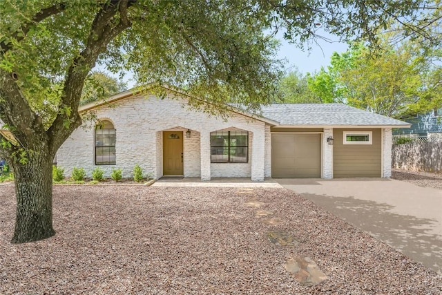 2009 Scofield Ln, Austin, TX 78727 - view of front of property featuring concrete driveway, a garage, and a shingled roof