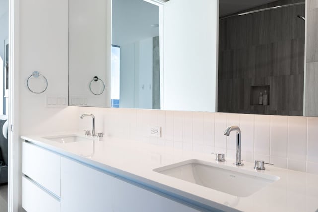 313 W 17th St Unit 1605, Austin, TX 78701 - bathroom featuring backsplash and double vanity