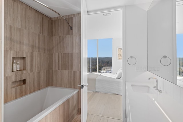 313 W 17th St Unit 1605, Austin, TX 78701 - ensuite bathroom featuring shower / washtub combination, vanity, and wood finished floors