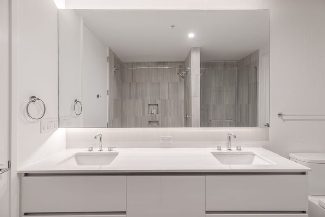 313 W 17th St Unit 1605, Austin, TX 78701 - full bath with toilet, double vanity, a tile shower, and tile walls