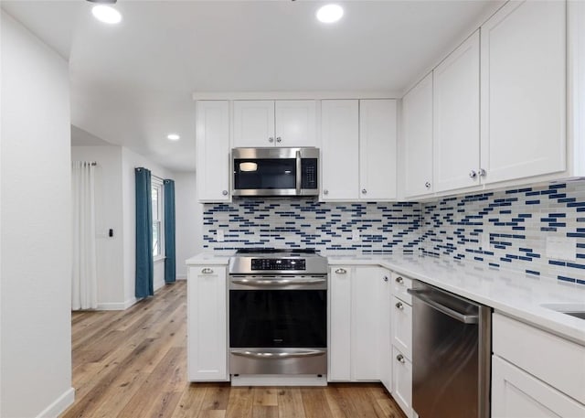 12300 Cassady Dr, Austin, TX 78727 - kitchen featuring appliances with stainless steel finishes, light countertops, tasteful backsplash, and recessed lighting