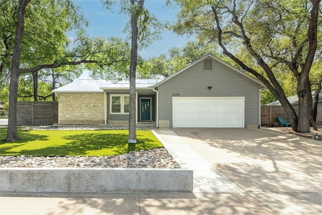 12300 Cassady Dr, Austin, TX 78727 - ranch-style home with an attached garage, concrete driveway, and stone siding