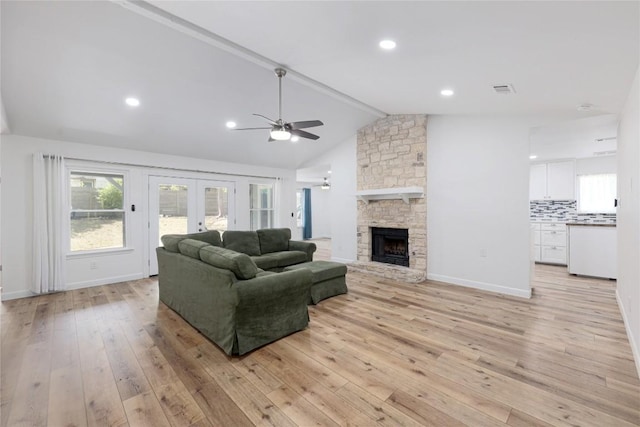12300 Cassady Dr, Austin, TX 78727 - living room featuring ceiling fan, light wood-type flooring, french doors, a fireplace, and healthy amount of natural light