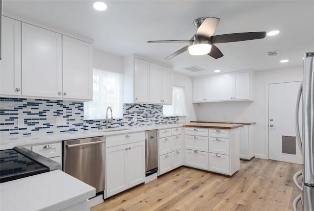 12300 Cassady Dr, Austin, TX 78727 - kitchen with appliances with stainless steel finishes, a ceiling fan, healthy amount of natural light, backsplash, and recessed lighting