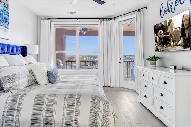 96 Island Dr Unit 44, Horseshoe Bay, TX 78657 - bedroom featuring access to outside, light wood-style flooring, and ceiling fan