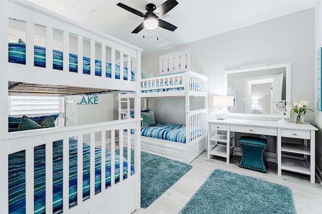 96 Island Dr Unit 44, Horseshoe Bay, TX 78657 - bedroom with wood finished floors, a desk, and ceiling fan