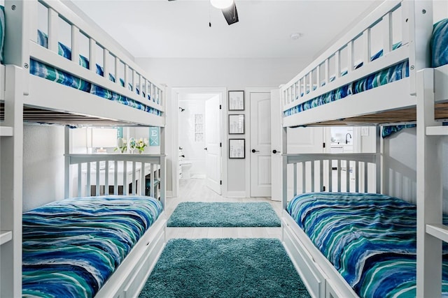 96 Island Dr Unit 44, Horseshoe Bay, TX 78657 - bedroom with connected bathroom and ceiling fan