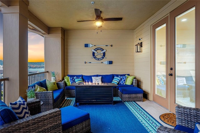 96 Island Dr Unit 44, Horseshoe Bay, TX 78657 - patio terrace at dusk with an outdoor living space with a fire pit and ceiling fan
