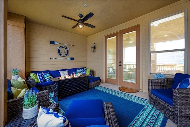 96 Island Dr Unit 44, Horseshoe Bay, TX 78657 - sunroom featuring an outdoor living space with a fire pit, french doors, and a ceiling fan