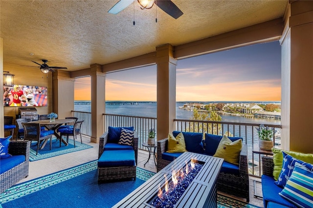 96 Island Dr Unit 44, Horseshoe Bay, TX 78657 - balcony featuring a ceiling fan, a water view, and an outdoor living space with a fire pit