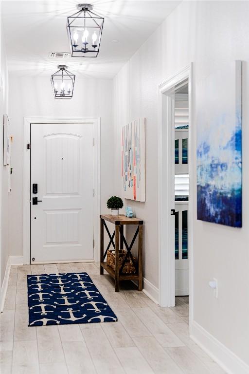 96 Island Dr Unit 44, Horseshoe Bay, TX 78657 - foyer featuring a chandelier and baseboards