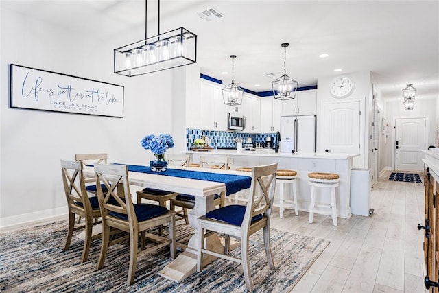 96 Island Dr Unit 44, Horseshoe Bay, TX 78657 - dining space with a chandelier, recessed lighting, and light wood-style floors