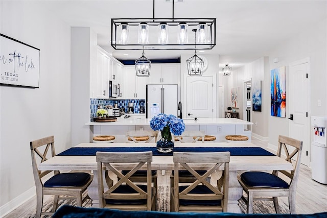 96 Island Dr Unit 44, Horseshoe Bay, TX 78657 - dining room with light wood-style floors and a chandelier