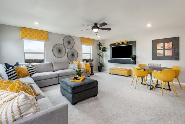 7805 Tranquil Glade Trl, Austin, TX 78744 - carpeted living area featuring baseboards, ceiling fan, and plenty of natural light
