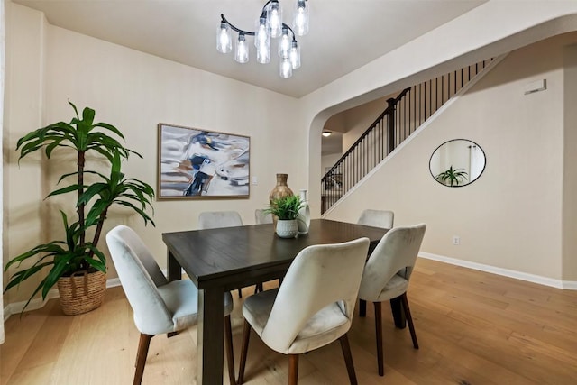 3615 Turkey Path Bnd, Cedar Park, TX 78613 - dining area featuring wood finished floors, arched walkways, and a chandelier