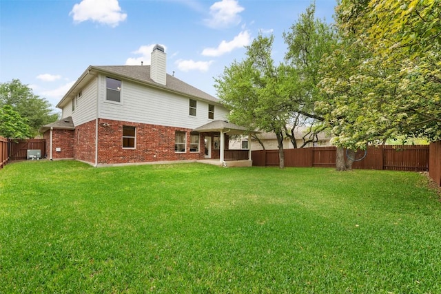 3615 Turkey Path Bnd, Cedar Park, TX 78613 - rear view of house with brick siding, a gazebo, a fenced backyard, and a chimney
