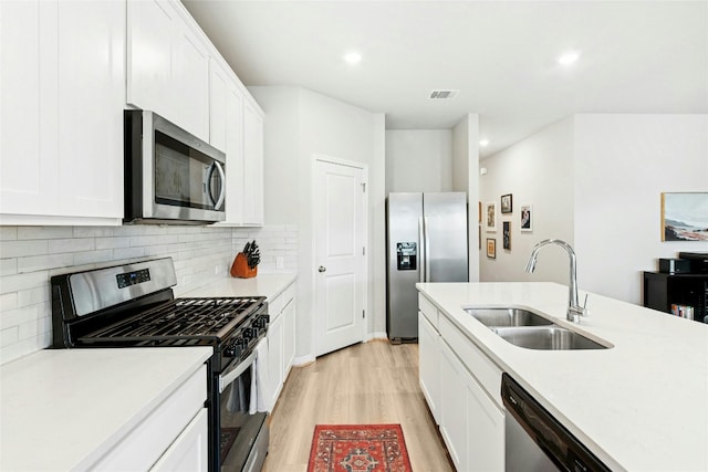 806 Vineyard Falls Rd, Austin, TX 78748 - kitchen with appliances with stainless steel finishes, a sink, light wood-style flooring, light countertops, and decorative backsplash