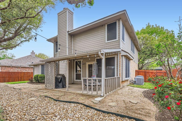 706 Belmont Dr, Georgetown, TX 78626 - rear view of property featuring a patio, a chimney, fence, and central AC unit