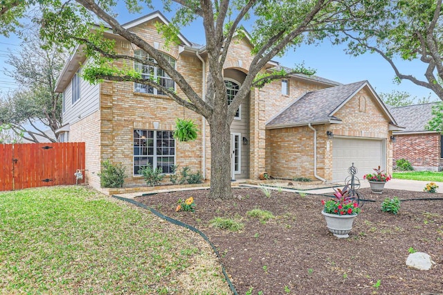 706 Belmont Dr, Georgetown, TX 78626 - traditional-style house featuring driveway, a front yard, fence, brick siding, and a garage
