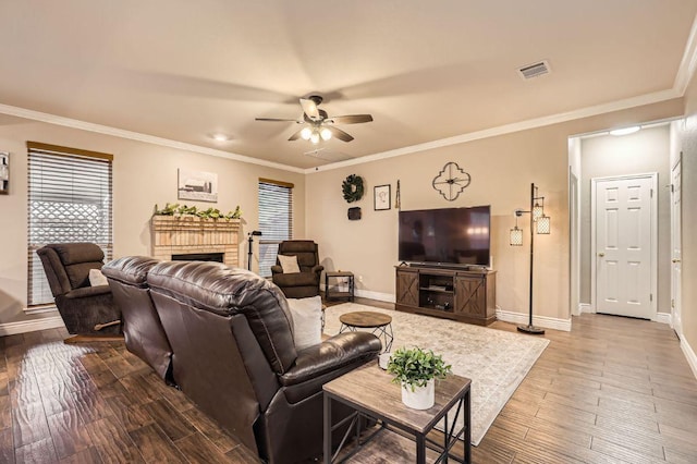 706 Belmont Dr, Georgetown, TX 78626 - living room featuring a brick fireplace, baseboards, visible vents, a ceiling fan, and wood finished floors