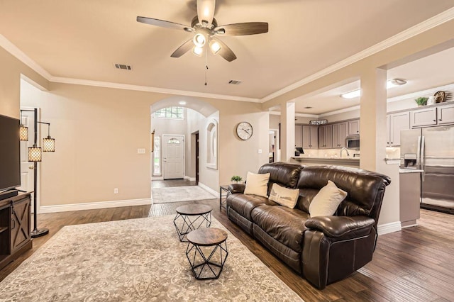 706 Belmont Dr, Georgetown, TX 78626 - living area featuring arched walkways, visible vents, a ceiling fan, and wood finished floors