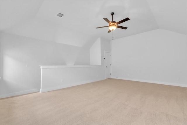 additional living space with lofted ceiling, ceiling fan, light carpet, and baseboards