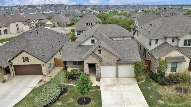 view of front of home with driveway, a residential view, a shingled roof, and fence