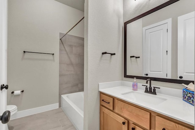 full bathroom featuring vanity, toilet, bathing tub / shower combination, tile patterned flooring, and baseboards