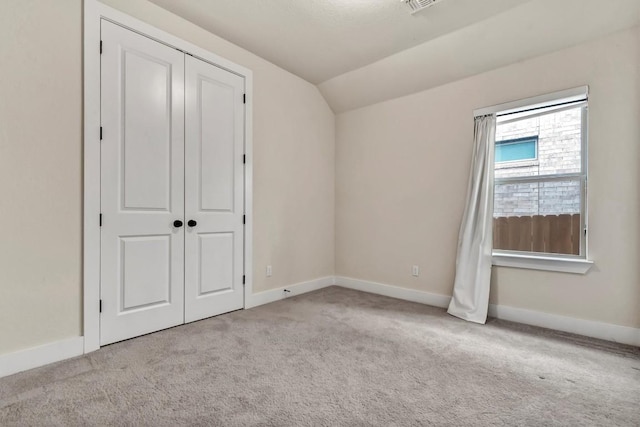 1305 Texas Ash Ln, Georgetown, TX 78628 - unfurnished bedroom with lofted ceiling, carpet floors, and a closet