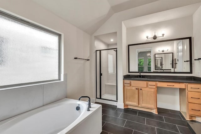 full bathroom featuring tile patterned floors, vanity, a stall shower, a garden tub, and lofted ceiling