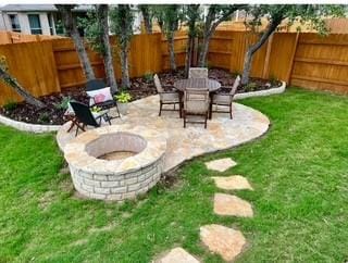 view of yard featuring a fire pit and a patio